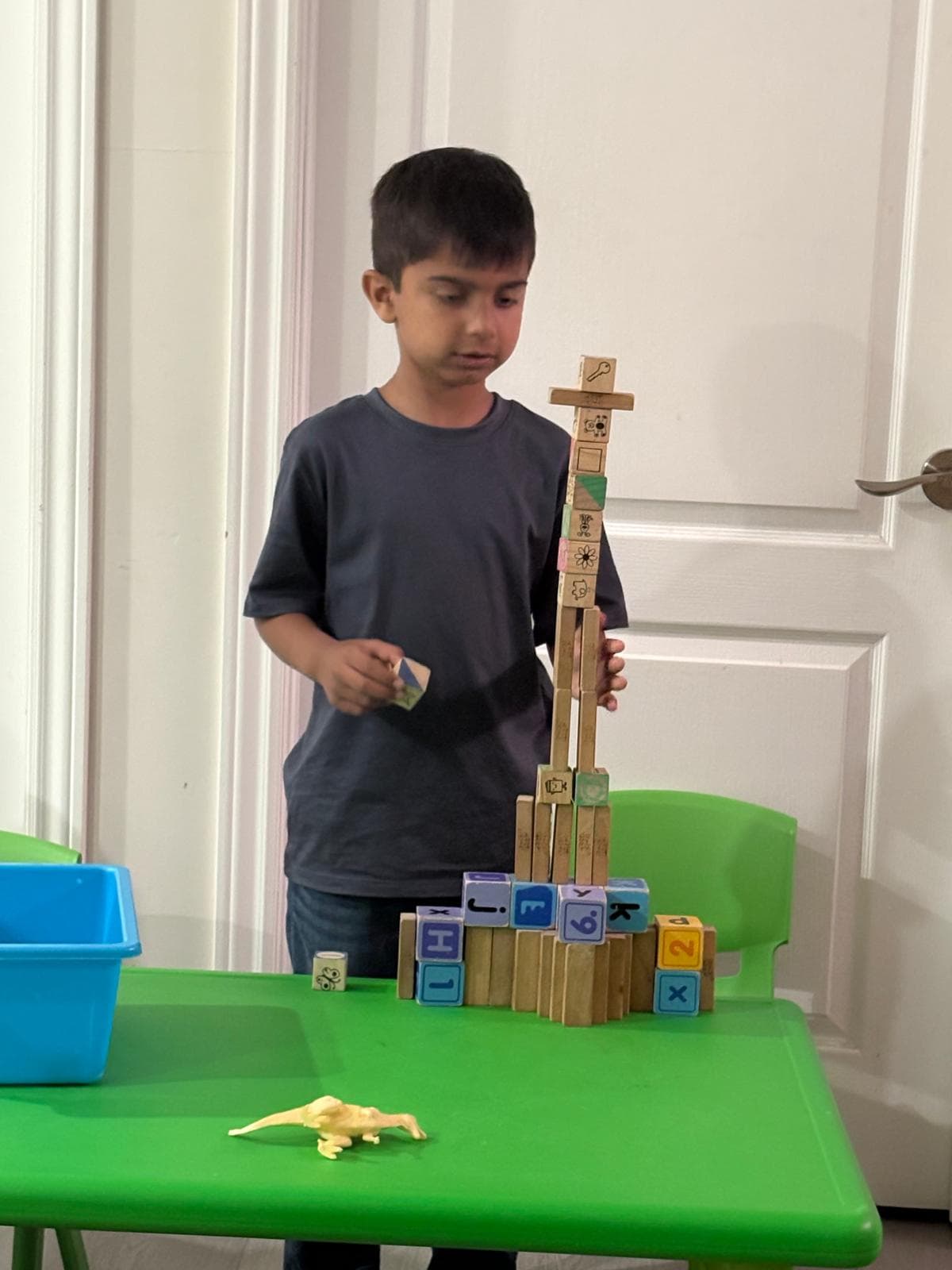 1 kid building a tower with jenga blocks
