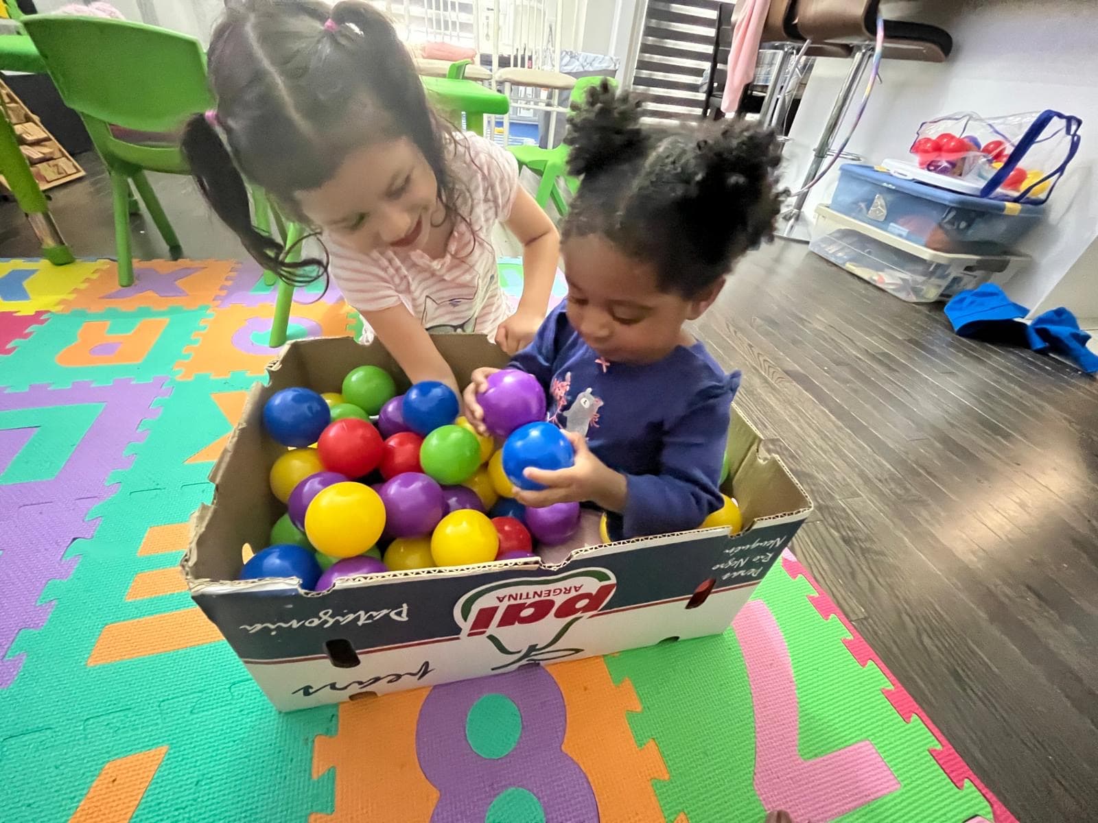 2 kids playing in diy ball pool
