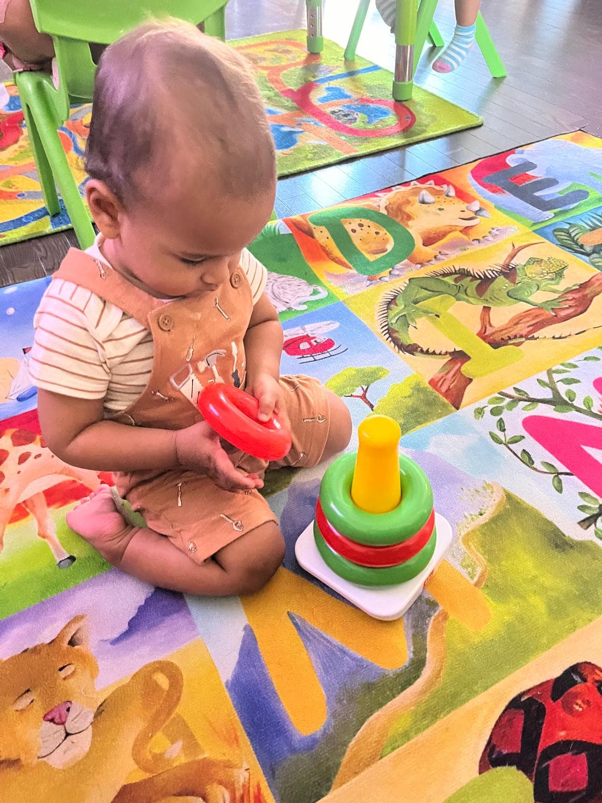 Infant playing with tower of hanoi