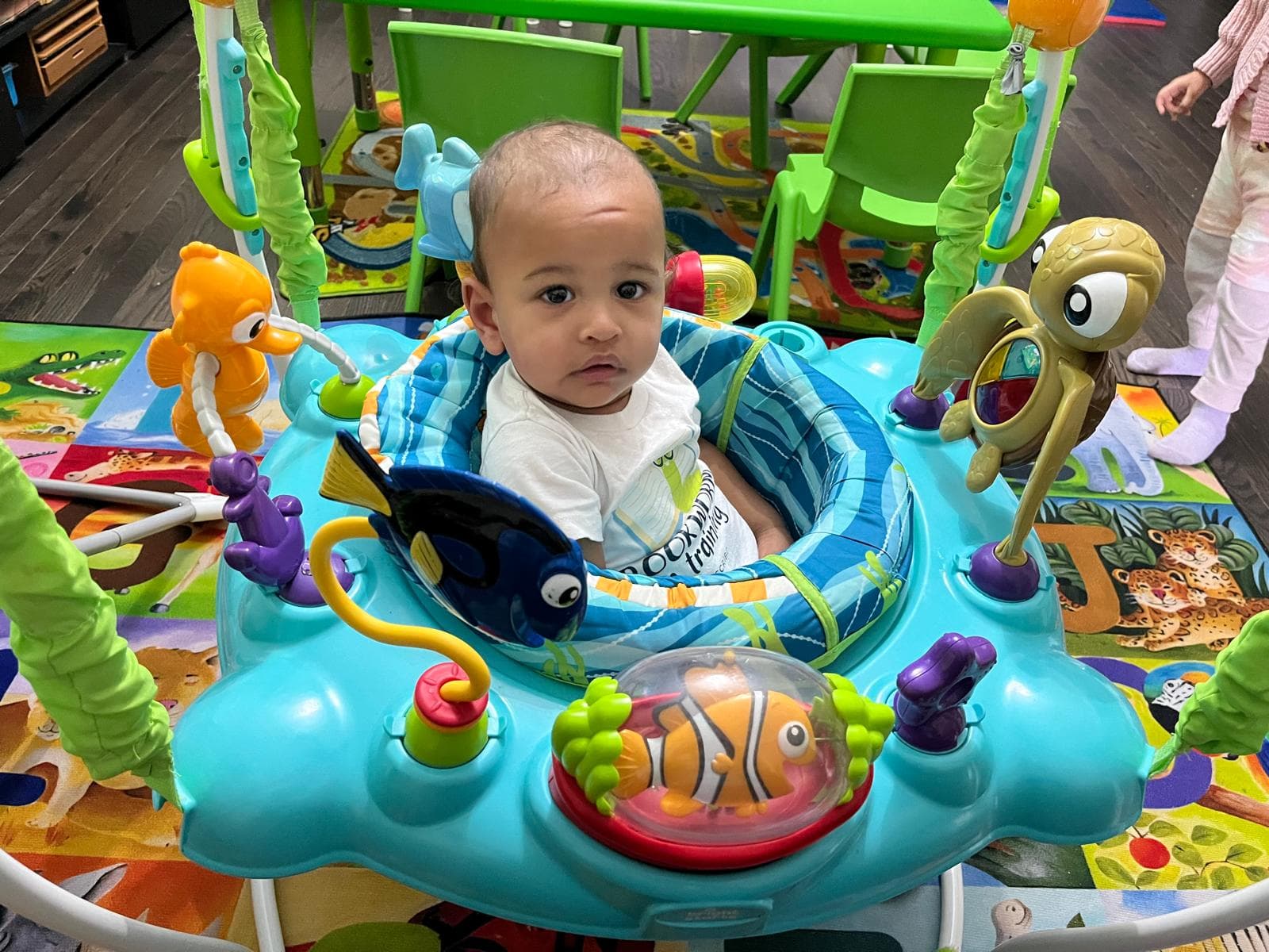 Infant standing in activity table